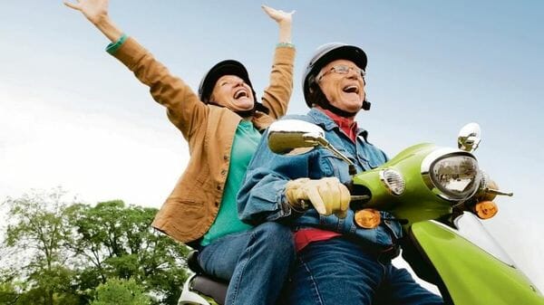 when can I afford to retire? retired couple on motorbike